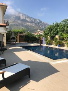 a swimming pool with a mountain in the background at Casa Santos Kyrenia in Kyrenia