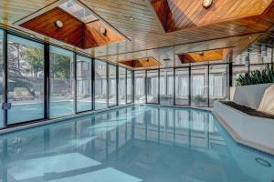 a swimming pool in a house with windows at DoubleTree by Hilton Atlanta Northwest/Marietta in Atlanta