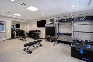 a fitness room with a gym with dumbbells and weights at Hilton Garden Inn Fort Myers in Fort Myers
