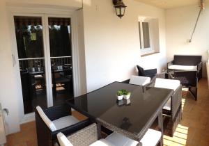 a dining room with a black table and chairs at Le Diodon De Sagone in Sagone