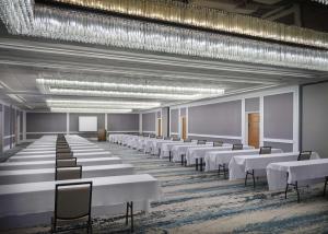 a large room with white tables and chairs at Embassy Suites by Hilton Tucson East in Tucson