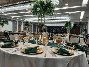 a long table with green plates and glasses on it at Embassy Suites by Hilton Tucson East in Tucson