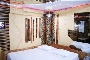 Postel nebo postele na pokoji v ubytování Mamba Hotel