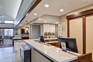 a kitchen with a counter with a computer on it at Homewood Suites by Hilton Kansas City/Overland Park in Overland Park