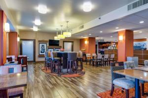 a restaurant with tables and chairs and a bar at Hampton Inn Johnson City in Johnson City