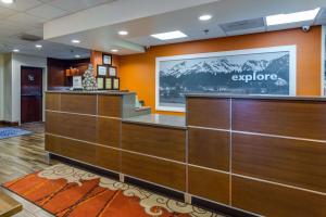 an office lobby with a reception desk and a sign that says explore at Hampton Inn Johnson City in Johnson City