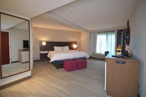 a hotel room with a bed and a large mirror at Hampton Inn Salem East - Electric Road in Salem +31 photos