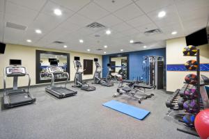 a gym with treadmills and machines in a room at Hampton Inn Kyle in Kyle