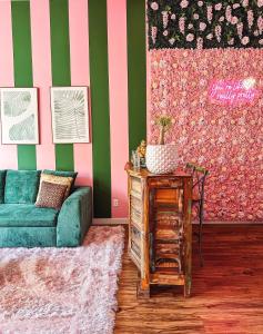 a living room with a green and pink striped wall at Dreaming With Dolly - Luxe Stay Near Broadway in Nashville