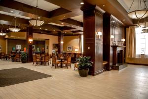 a lobby with a restaurant with tables and chairs at Hampton Inn & Suites Albany-Downtown in Albany