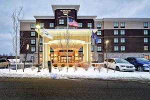 a hotel with cars parked in front of it at Homewood Suites by Hilton Novi Detroit in Novi