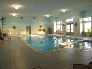 a large indoor swimming pool in a building at Hampton Inn Birch Run in Birch Run