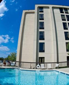 un hôtel avec une piscine en face d'un bâtiment dans l'établissement Hampton Inn Philadelphia-Airport, à Philadelphie