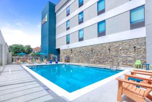 a swimming pool in front of a building at Home2 Suites By Hilton Daphne Spanish Fort in Daphne