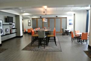 a dining room and living room with a table and chairs at Hampton Inn Carrizo Springs in Carrizo Springs