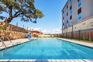 a swimming pool in front of a building at Hampton Inn By Hilton Bulverde Texas Hill Country in Bulverde