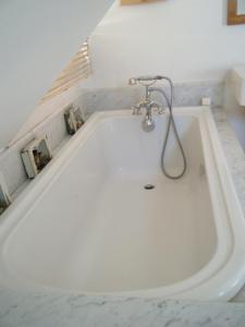 a white bath tub in a bathroom at La Source in Condette