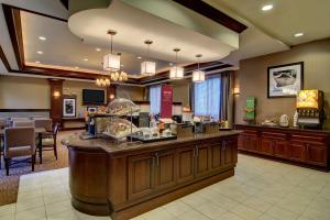 a hotel lobby with a counter and a restaurant at Hampton Inn & Suites Washington-Dulles International Airport in Sterling