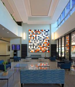 a lobby with a large painting on the wall at DoubleTree by Hilton Hotel Miami Airport & Convention Center in Miami
