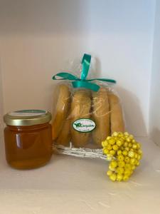 a package of bread and a jar of honey and grapes at Serendipity Living Studio in Kýthira