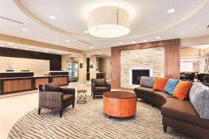 a living room with a couch and a table at Homewood Suites Atlanta Airport North in Atlanta