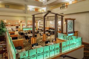 a restaurant with tables and chairs in a library at DoubleTree Suites by Hilton Seattle Airport/Southcenter in Tukwila