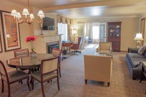 a living room with a dining table and a living room at Hotel Roanoke & Conference Center, Curio Collection by Hilton in Roanoke