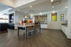 a restaurant with a counter with a bar in it at Hilton Garden Inn Atlanta Airport North in Atlanta