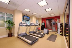 a gym with treadmills and machines in a room at Hilton Garden Inn Atlanta Airport North in Atlanta