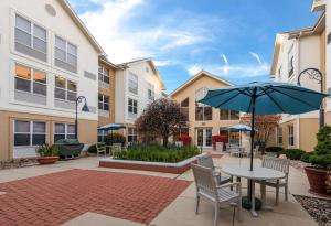 a patio with a table and an umbrella at Hampton Inn & Suites Chicago-Hoffman Estates in Hoffman Estates