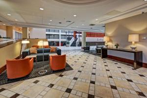 a lobby with a couch and chairs in a building at Hilton Knoxville Airport in Alcoa