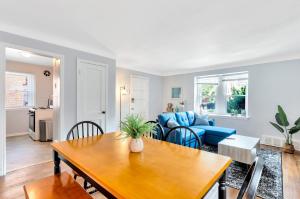 a living room with a table and a blue couch at Comfortable Family Residence near Downtown Detroit in Detroit