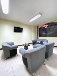 a living room with couches and a flat screen tv at Blue Horizon, Galápagos in Puerto Baquerizo Moreno