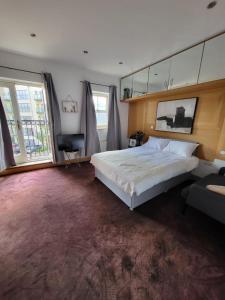 a bedroom with a large bed and a large window at Camden, London, Holloway Rooms 20 Busby Place, NW5 2SR in London