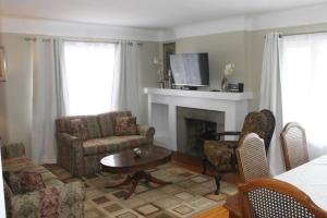 a living room with a couch and a fireplace at Niagara Riverview Closest to Falls, Free Breakfast Delivered Daily in Niagara Falls