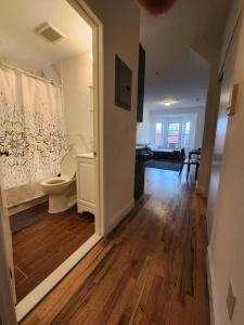 a bathroom with a toilet in a room at Deluxe Studio minutes from NYC! in Union City