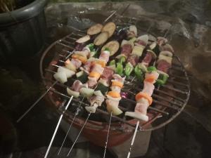 a grill with many different types of food on it at Tzy-No Family Cottage in Balong