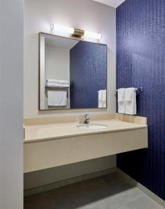 a bathroom with a sink and a mirror at Fairfield Inn & Suites Burlington in Burlington