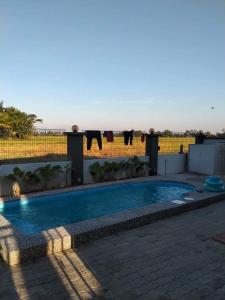 a swimming pool on the back of a house at Murni Inn Kampung Perigi in Yan