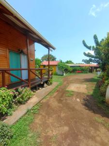 a house with a dirt road in front of it at Hostal Makohe Rapa Nui in Hanga Roa