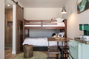 a bedroom with two bunk beds and a table at California Inn in Anaheim