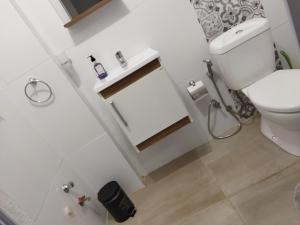 a white bathroom with a toilet and a sink at Monoambiente in Mercedes