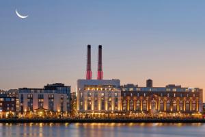 a large building with two smoke stacks on top of it at JW Marriott Savannah Plant Riverside District in Savannah