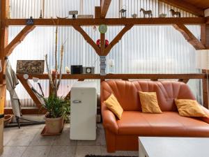 a living room with a leather couch in a room at Cosy apartment with sauna in the Black Forest in Sulz am Neckar