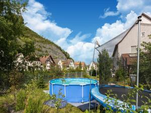 a swimming pool in the yard of a house at Cosy apartment with sauna in the Black Forest in Sulz am Neckar