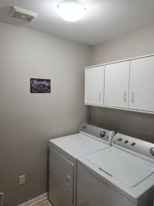a kitchen with a washer and dryer in a room at Beautiful home away from home in Milton