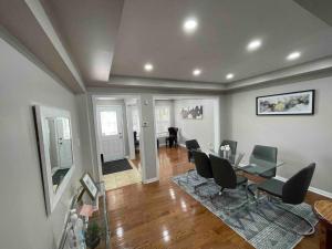 a living room with a glass table and chairs at Beautiful home away from home in Milton