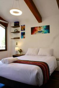a bedroom with a large white bed in a room at Casa de ensueño en el Valle Sagrado in Calca