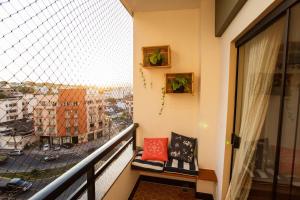a balcony with a view of a city at Areia Preta Park Studio | Salma Haddad in Guarapari