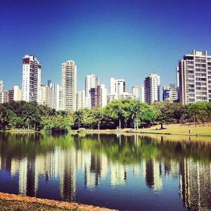 a city skyline with a pond in front of a city at Hostel Bimba Goiânia - Unidade 02 in Goiânia